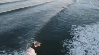 Surfer rides wave - Huntington Beach - California - March 11th, 2021 - 6:28am PST - DJI Inspire 2