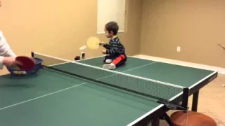 Cute baby playing table tennis