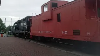 IN GOD with an Old Train locomotive and caboose at depot in Carbondale Illinois