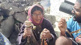 Elder lady spinning prayer wheel near Dhankar village in Spiti, Himachal