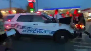 Protesters hit by police car as it drives through crowd in Detroit