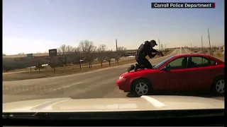 Police officer clings to roof of suspect's car in new video of Iowa car chase