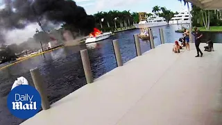 Shocking moment boat explodes into a ball of flames forcing 21 people to be rescued