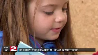 Kids read to Dixie the dog.