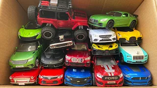 Box full of model Cars, Jeep, Mercedes Benz, Bugatti, Dodge Charger, BMW, Rolls Royce,