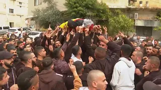 Mourners carry body of Palestinian man shot in West Bank by Israeli troops through streets