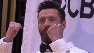 Hugh Jackman jumping  outside Tony Awards