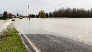 Water is flowing over Emerson Road near Everson