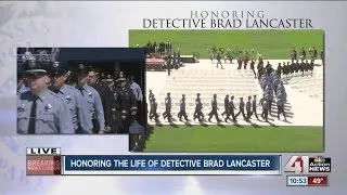 Officers enter Children's Mercy Park for the funeral of Det. Brad Lancaster