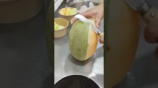 Skillful cantaloupe cutting street food