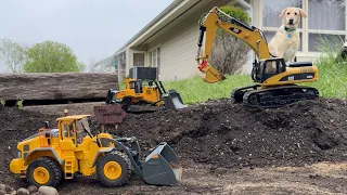 Moving materials at the job site, RC excavator CAT 330D, front end loader Volvo L260H, bulldozer