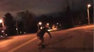 Downhill Skateboarder Hits Street Light