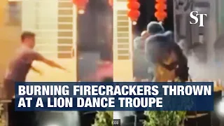 Malaysia: Burning firecrackers thrown at a lion dance troupe in Sandakan