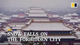 Snow falls on the Forbidden City in Beijing, China