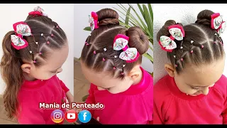 Girl's hairstyle with elastic bands and two ponytails or two buns