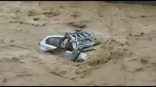 Rainstorm-Triggered Flood Damages Roads, Traps Tourists in Southwest China