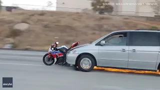 Caught on cam: Minivan drags motorcycle on Calif. freeway