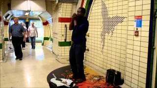 London Street Music. Harmonica Player in Piccadilly Circus Station