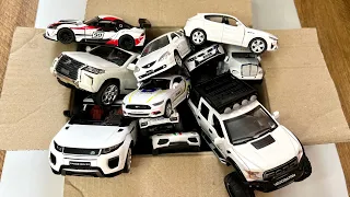 Box full of various miniature cars Jaguar, Peugeot, Renault, Hyundai, Mazda, Volvo, Honda, Opel #167