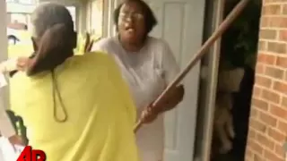 Raw Video: Woman Attacks TV Crew With Hoe