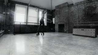 Woman Hula Hoops While Wearing High Heeled Roller Skates - 1062382-2