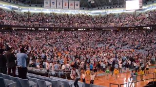 Tar Heel fans storm the floor of the Dean Dome after win