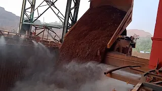 IRON ORE DUMPING BY KOMATSU & CATERPILLAR DUMP TRUCK IN HOPPER OF KOBELCO GYRATORY CONE CRUSHER