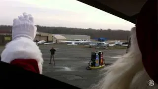 Helicopter delivers Santa to Christmas parade
