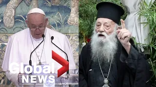 Orthodox priest heckles Pope Francis during Greece visit to highlight migrant crisis