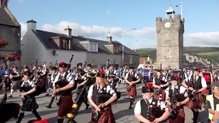 Massed Pipe Bands street parade after the 2019 Dufftown Highland Games in Moray, Scotland