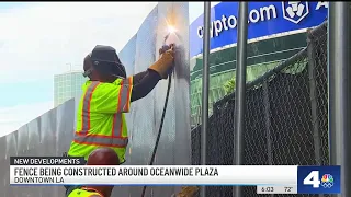 Crews begin building fence around graffiti-covered towers in DTLA