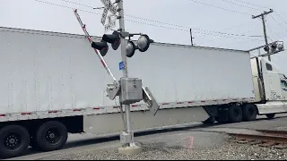 Truck gets hit by crossing gate! Train almost hit truck! Train meet! Long intermodal with 5 engines!