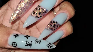 light blue nails with LV design notpolish acrylic
