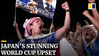 Japanese fans celebrate their team’s stunning World Cup upset victory over Germany