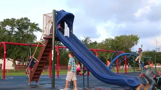 Students play on new playground for first day of school