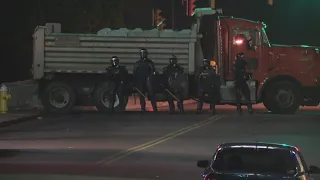 Police in riot gear deploy tear gas against protestors in Downtown Akron