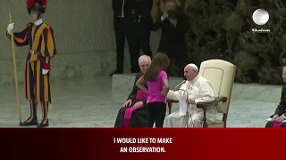 Smiling Pope Francis allows a little girl  to run free on stage