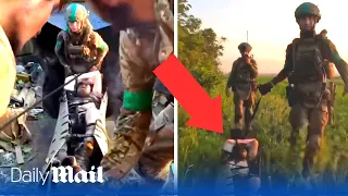 Moment hero Ukraine soldiers carry their wounded comrade off the battlefield