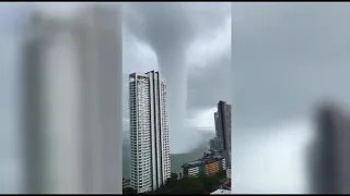 Footage captures mega water spout dwarfing high-rise building