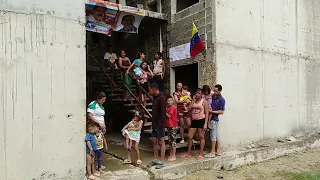 Desperate families take over unfinished high-rise apartment in Venezuela