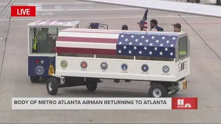 Casket carrying US Senior Airman Roger Fortson's body removed from plane at Atlanta airport