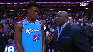 Bam Adebayo jumps on Jimmy Butler's back during postgame interview.