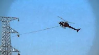 helicopter doing a power line pull at Karra mining operation western australia.MOV