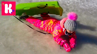 Katy on a sled and in a Puddle