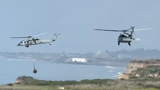 Amazing closeup highly skilled helicopter pilots loading amphibious assault ship offshore San Diego