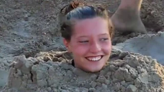 Girl buried in sand