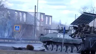 Russian soldiers atop BMP-2 aim at Ukrainian civilians