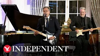 Secretary Antony Blinken plays guitar serenading State Department crowd