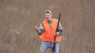 man catches flying bird with bare hand