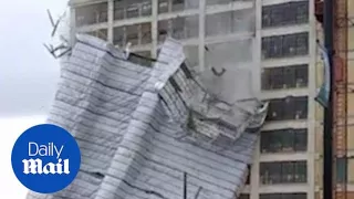 Scaffolding of an entire building falls off after high winds - Daily Mail